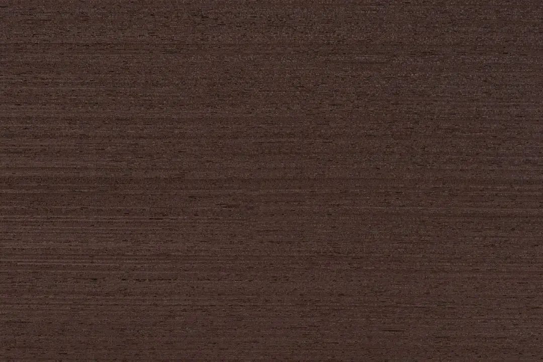 Dark, textured wood veneer surface.