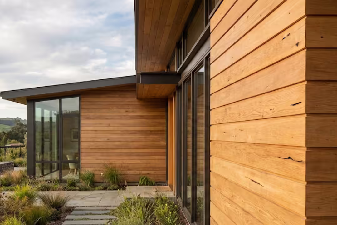 High-quality Accoya wood siding shining under soft sunlight